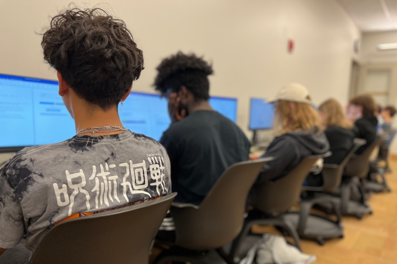 Teens doing computer science activities in a computer lab
