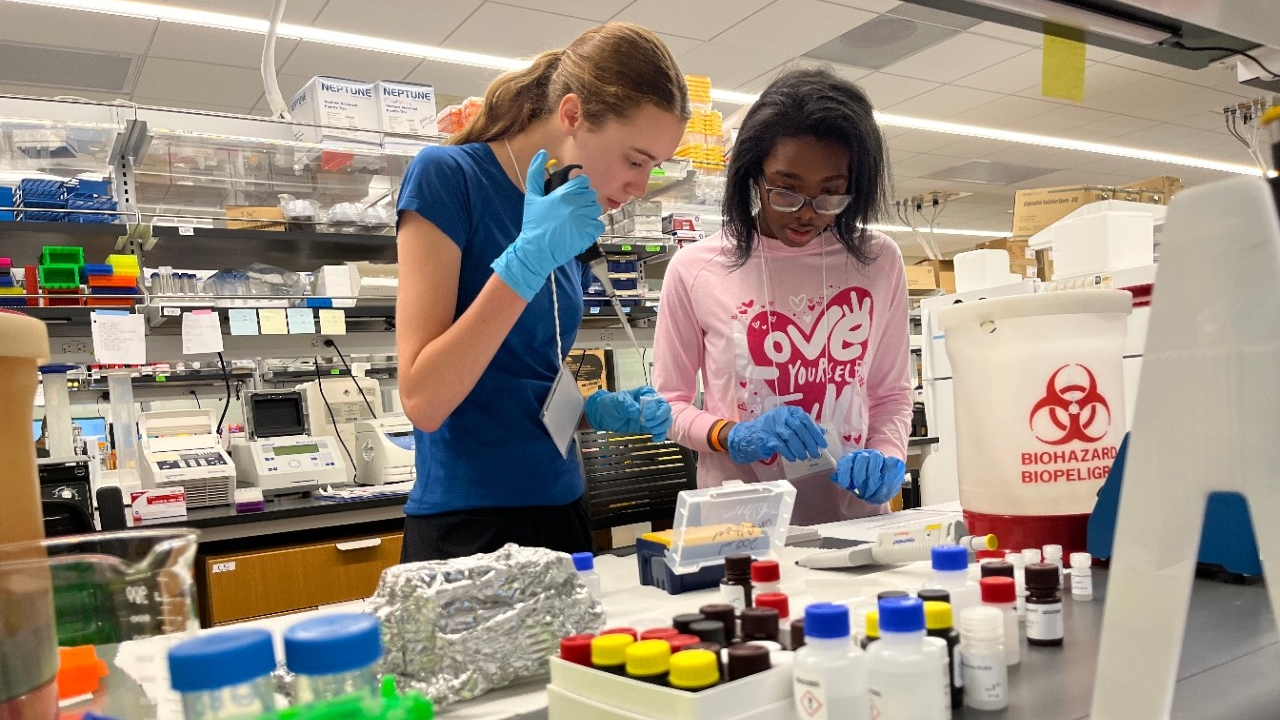 Two high school students conducting neuroscience experiments in a biology lab at Northern Kentucky University