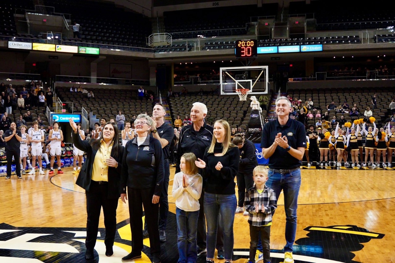 Jane Meier with family and Christina Roybal at banner unveiling