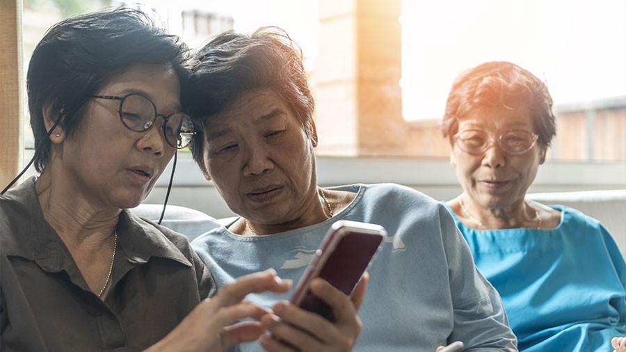 A group of women looking at a smart phone